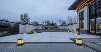 there is a courtyard in the middle of the day with light on it's steps, and large grass area on the ground