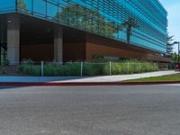 two grey blocks sitting next to a tall building on a sidewalk in front of grass