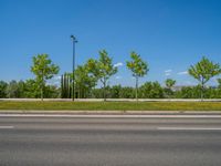 a concrete structure made into rows of orange and yellow poles are on a cement sidewalk