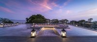 modern, outdoor seating at dusk on a rooftop pool with stunning views in the background