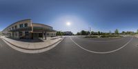 a fish - eye lens image of a school in a big town center with school building