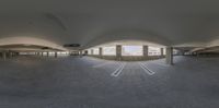 a fish eye shot of a building in a large room with a very big window