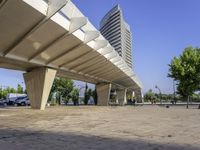 a paved walkway that goes up to a building in the city that has a low rise