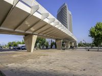 a paved walkway that goes up to a building in the city that has a low rise