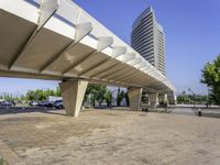 a paved walkway that goes up to a building in the city that has a low rise