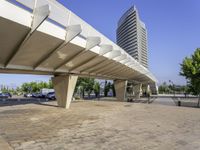 a paved walkway that goes up to a building in the city that has a low rise