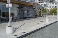 the exterior of a restaurant and water features potted flowers near a pool in front