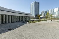 the empty square is located at a university with a variety of windows and a building to the side