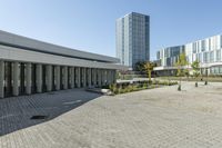 the empty square is located at a university with a variety of windows and a building to the side