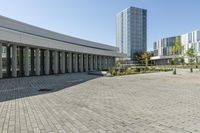 the empty square is located at a university with a variety of windows and a building to the side