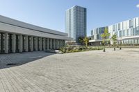 the empty square is located at a university with a variety of windows and a building to the side