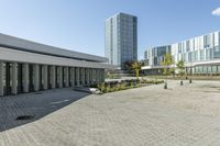 the empty square is located at a university with a variety of windows and a building to the side