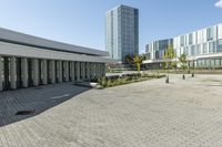 the empty square is located at a university with a variety of windows and a building to the side