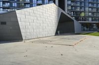 the building is painted metal and is surrounded by leaves and grass in front of it