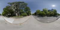 a fish eye view of a half pipe in a town area and a few people walking outside