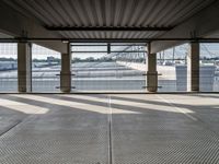 an empty train station with several cars parked in the back ground and on a dock