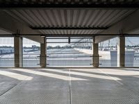 an empty train station with several cars parked in the back ground and on a dock