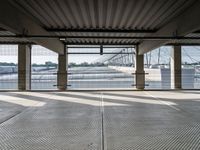 an empty train station with several cars parked in the back ground and on a dock