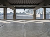 an empty train station with several cars parked in the back ground and on a dock