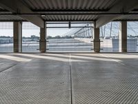 an empty train station with several cars parked in the back ground and on a dock