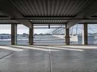 an empty train station with several cars parked in the back ground and on a dock