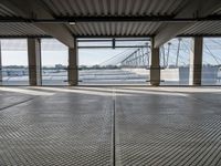 an empty train station with several cars parked in the back ground and on a dock