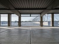 an empty train station with several cars parked in the back ground and on a dock