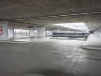 a car park that has the parking lots opened to let it inside of the building