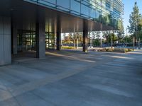 two grey blocks sitting next to a tall building on a sidewalk in front of grass