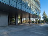 two grey blocks sitting next to a tall building on a sidewalk in front of grass