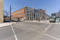 two buildings are built next to the city streets and some cars have stopped at the corner