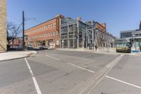 two buildings are built next to the city streets and some cars have stopped at the corner