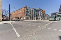 two buildings are built next to the city streets and some cars have stopped at the corner