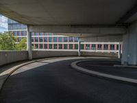 a car is driving on the highway through an underground parking garage area in a city