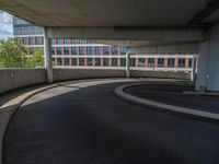 a car is driving on the highway through an underground parking garage area in a city