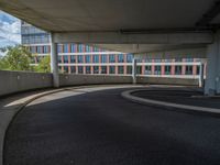 a car is driving on the highway through an underground parking garage area in a city