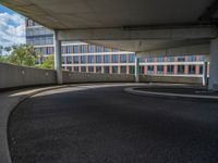 a car is driving on the highway through an underground parking garage area in a city