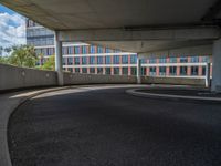 a car is driving on the highway through an underground parking garage area in a city