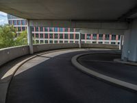 a car is driving on the highway through an underground parking garage area in a city