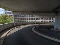 a car is driving on the highway through an underground parking garage area in a city