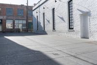 a building with lots of windows and some bricks on it's side with a fire hydrant