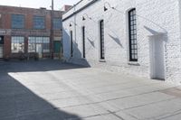 a building with lots of windows and some bricks on it's side with a fire hydrant