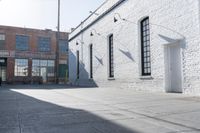 a building with lots of windows and some bricks on it's side with a fire hydrant