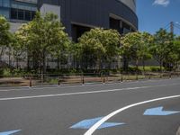 empty road with white lines on the streets of city area against cloudy blue sky on a sunny day