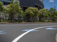 empty road with white lines on the streets of city area against cloudy blue sky on a sunny day