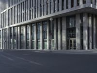 a large tall building sitting on the side of a road between two buildings of different sizes