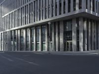 a large tall building sitting on the side of a road between two buildings of different sizes