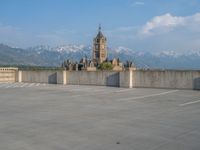 several large empty parking spaces in the city with buildings nearby in front of them -