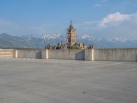 several large empty parking spaces in the city with buildings nearby in front of them -