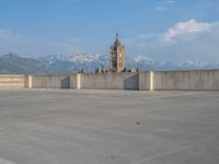 several large empty parking spaces in the city with buildings nearby in front of them -